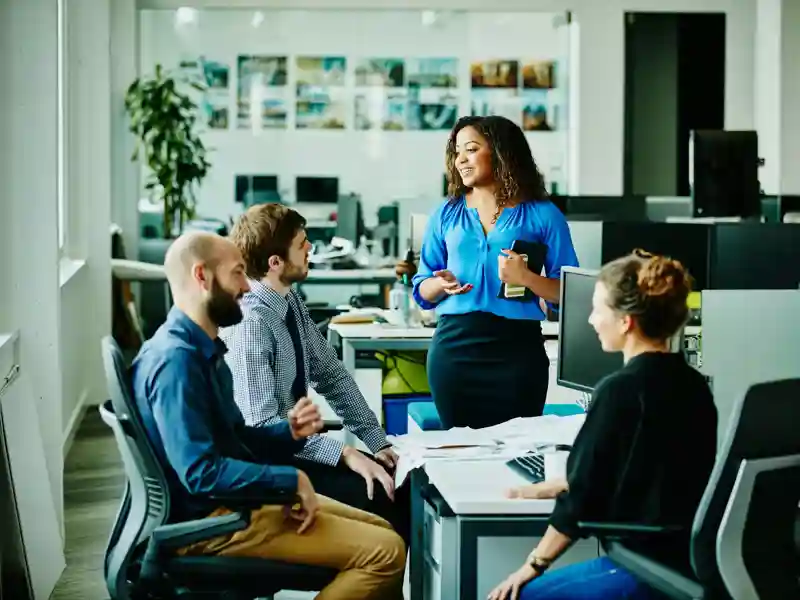 Businesswoman leading meeting with colleagues